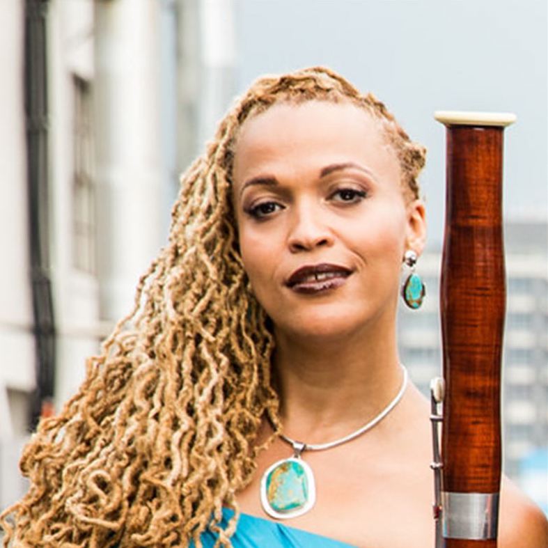 Headshot of Monica Ellis and her bassoon.